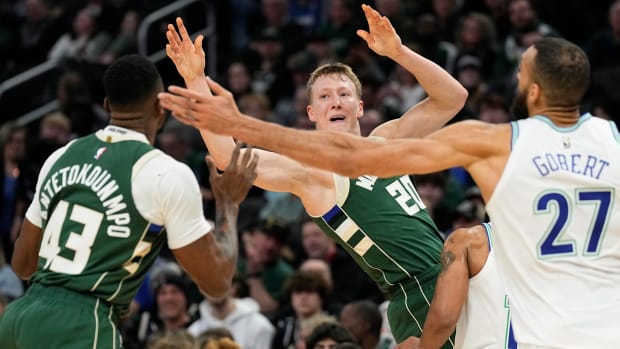 Feb 8, 2024; Milwaukee, Wisconsin, USA; Milwaukee Bucks guard AJ Green (20) passes the ball towards forward Thanasis Antetokounmpo (43) during the fourth quarter against the Minnesota Timberwolves at Fiserv Forum.